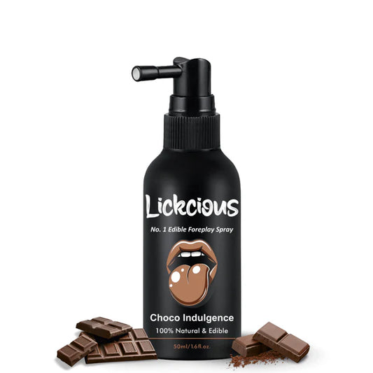 Black bottle of Lickcious Choco Indulgence edible foreplay spray with chocolate bars on a white background